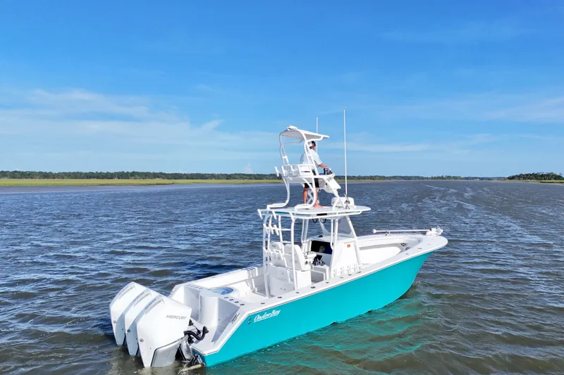 Slide: The Image of 2021 Onslow Bay 33 Tournament boat on open water under clear blue sky. - 21
