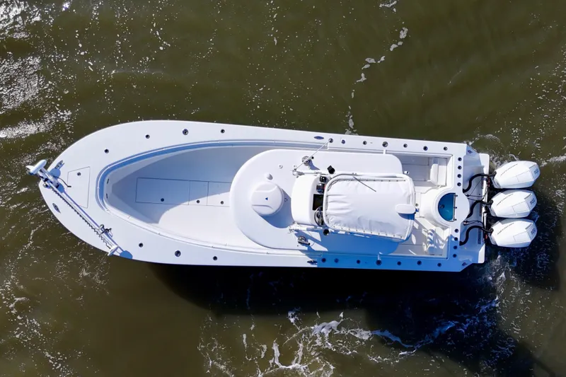 Slide: The Image of Aerial view of 2021 Onslow Bay 33 Tournament boat with triple engines on water. - 22