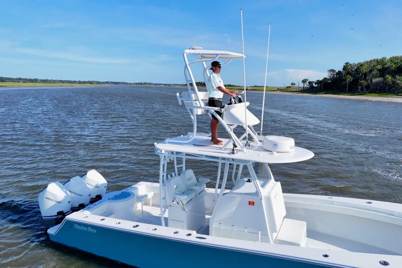 Slide: The Image of 2021 Onslow Bay 33 Tournament boat cruising on a scenic waterway. - 25