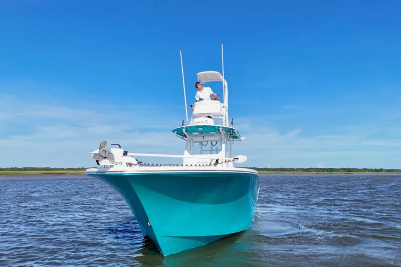 Slide: The Image of 2021 Onslow Bay 33 Tournament boat cruising on open water under clear blue sky. - 33