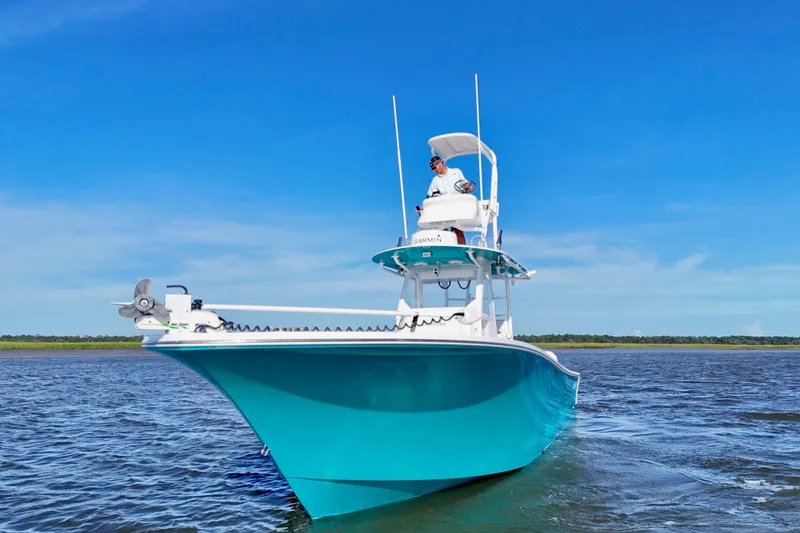 Slide: The Image of 2021 Onslow Bay 33 Tournament boat on water under clear blue sky. - 35