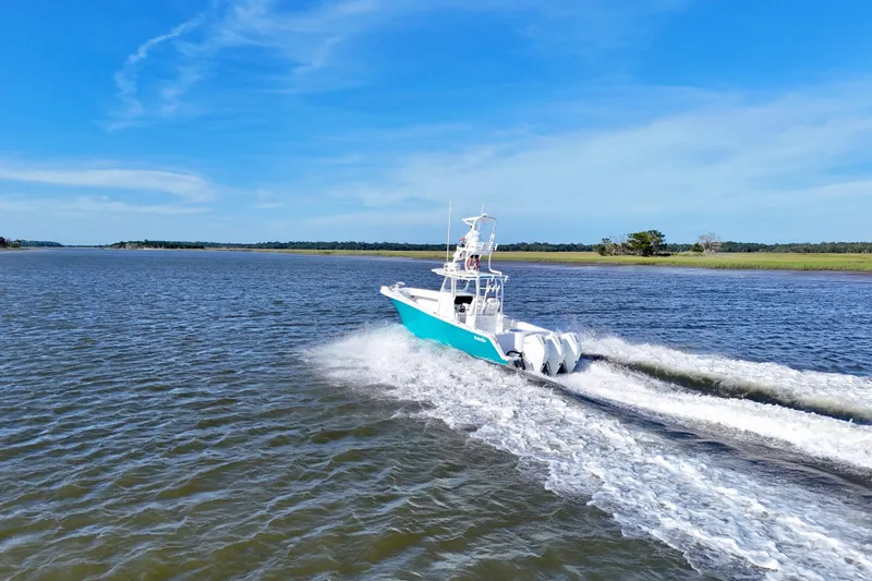Slide: The Image of 2021 Onslow Bay 33 Tournament boat cruising on open water under clear blue sky. - 38