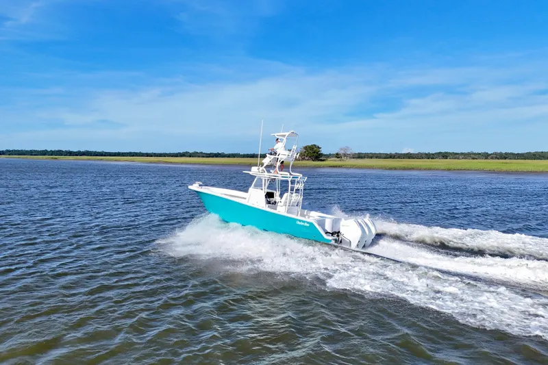 Slide: The Image of 2021 Onslow Bay 33 Tournament boat cruising on open water under clear blue sky. - 39