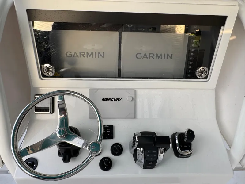 Slide: The Image of 2020 Onslow Bay 33 Tournament boat dashboard with Garmin displays and Mercury controls. - 50