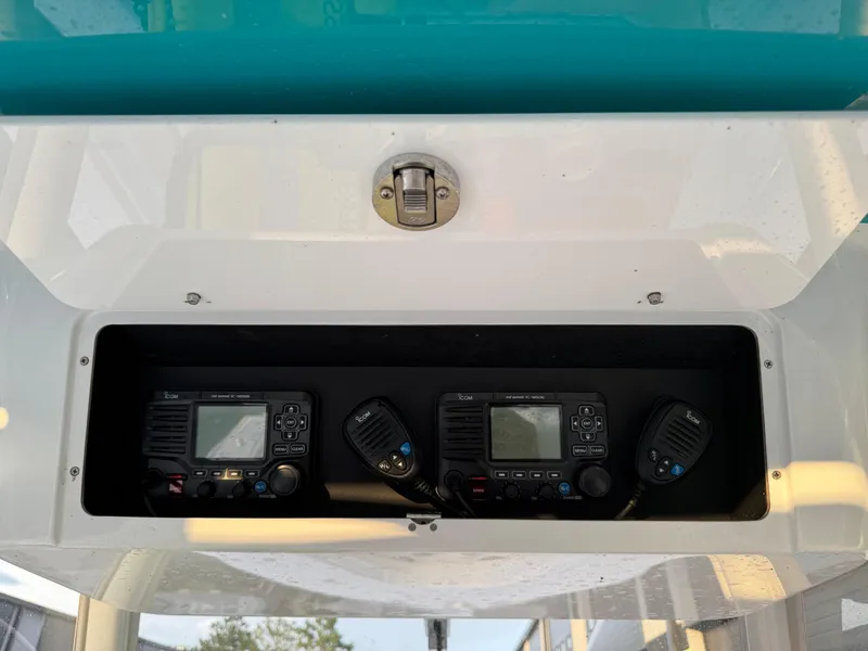 Slide: The Image of 2020 Onslow Bay 33 Tournament boat radio equipment in storage compartment. - 51