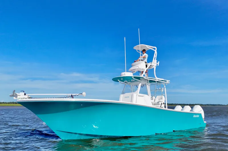Slide: The Image of 2021 Onslow Bay 33 Tournament boat on water under clear blue sky. - 9