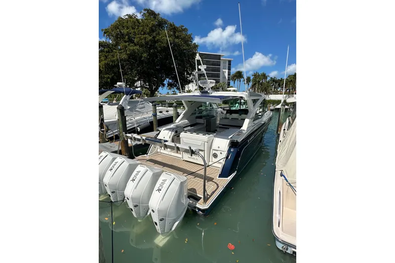 Slide: The Image of 2023 Formula 430 All Sport Crossover boat docked with multiple outboard engines. - 10