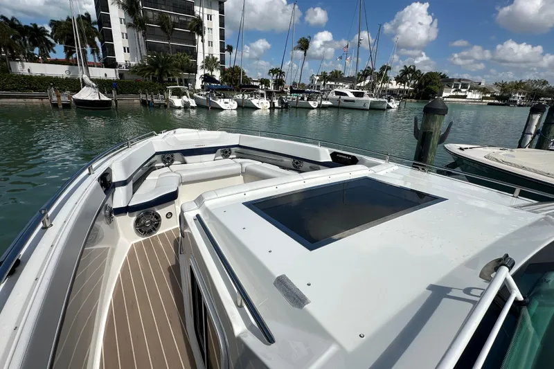 Slide: The Image of 2023 Formula 430 All Sport Crossover boat docked in a marina with clear skies. - 12