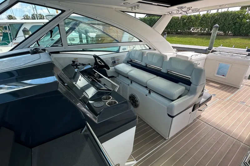 Slide: The Image of 2023 Formula 430 All Sport Crossover boat interior with helm and seating area. - 19