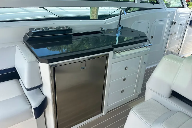 Slide: The Image of 2023 Formula 430 All Sport Crossover boat interior with kitchenette and seating area. - 21