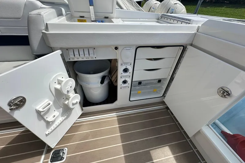Slide: The Image of 2023 Formula 430 All Sport Crossover boat interior storage with open cabinets and equipment. - 28