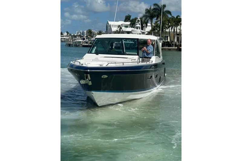 Slide: The Image of 2023 Formula 430 All Sport Crossover boat cruising in sunny waters. - 3