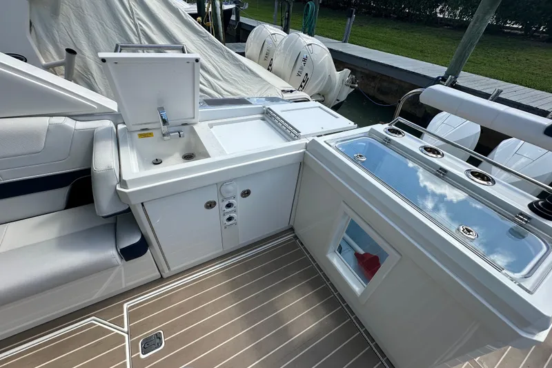 Slide: The Image of 2023 Formula 430 All Sport Crossover boat interior with sink and storage compartments. - 30