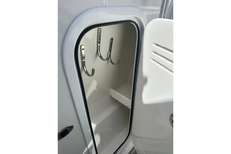 Slide: The Image of 2023 Formula 430 All Sport Crossover storage compartment with hooks and shelf. - 34