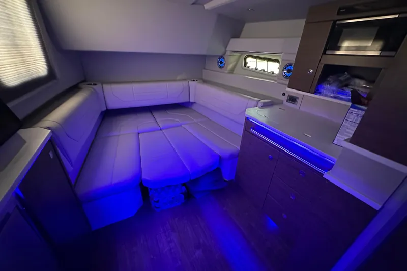 Slide: The Image of 2023 Formula 430 All Sport Crossover interior with blue ambient lighting and modern amenities. - 43