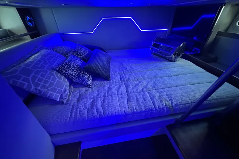Slide: The Image of 2023 Formula 430 All Sport Crossover cabin with blue LED lighting and cozy bedding. - 45