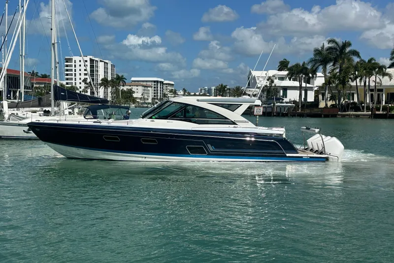 Slide: The Image of 2023 Formula 430 All Sport Crossover yacht cruising in a sunny marina. - 6