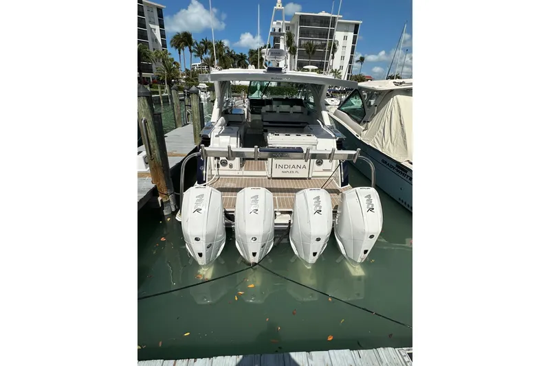 Slide: The Image of 2023 Formula 430 All Sport Crossover boat docked with four powerful outboard engines. - 7