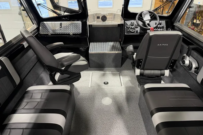 Slide: The Image of Interior of 2026 Lund 210 Heavy Gauge boat with modern seating and control panel. - 12