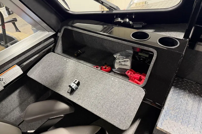 Slide: The Image of Interior of 2026 Lund 210 Heavy Gauge boat with storage compartment and cup holders. - 22