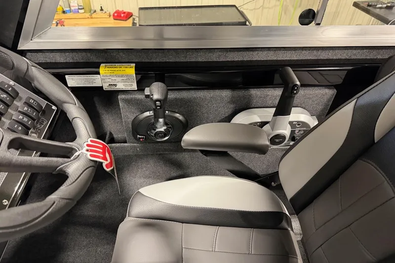 Slide: The Image of Interior of 2026 Lund 210 Heavy Gauge boat with steering wheel and controls. - 23