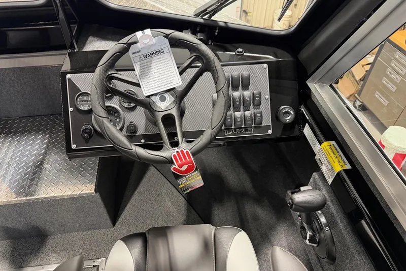 Slide: The Image of Interior of 2026 Lund 210 Heavy Gauge boat with steering wheel and control panel. - 5