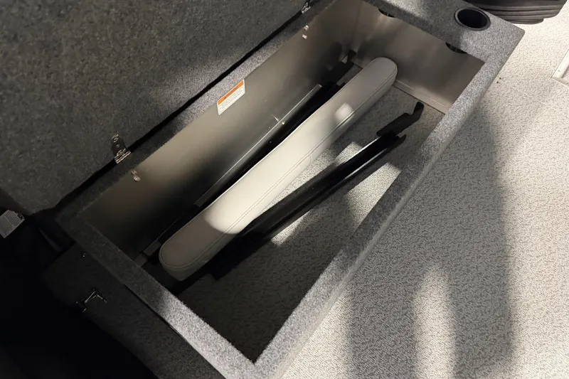 Slide: The Image of Open storage compartment in 2026 Lund 210 Heavy Gauge boat, featuring gray interior. - 8