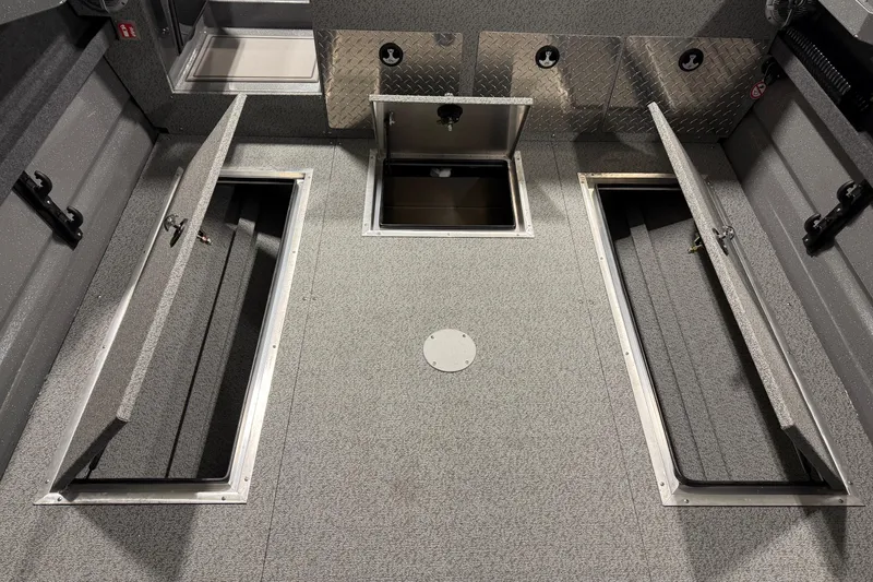 Slide: The Image of Interior view of 2026 Lund 210 Heavy Gauge boat with open storage compartments. - 9