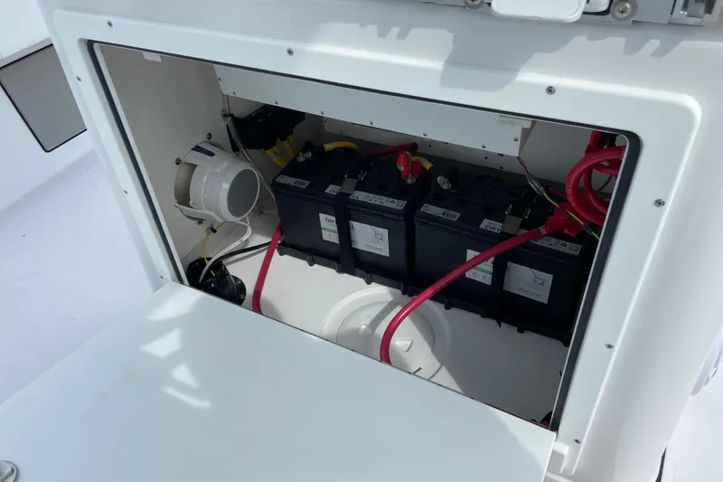 Slide: The Image of Battery compartment of 2026 Sportsman Masters 267 Bay Boat with wiring and components. - 12