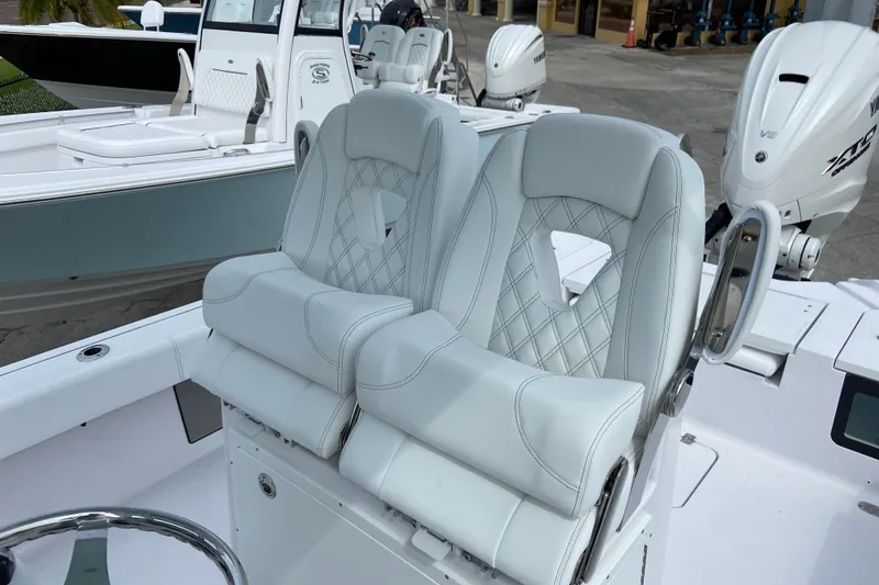 Slide: The Image of Luxurious seating on 2026 Sportsman Masters 267 Bay Boat with dual outboard engines. - 13
