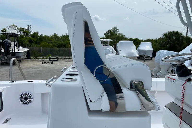 Slide: The Image of 2026 Sportsman Masters 267 Bay Boat interior with white seating and steering console. - 15