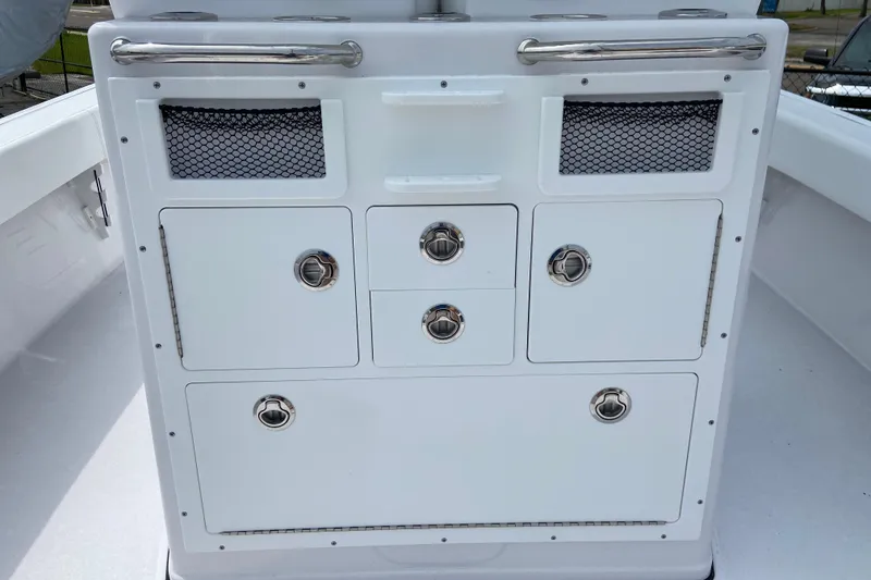 Slide: The Image of 2026 Sportsman Masters 267 Bay Boat storage compartments with stainless steel handles. - 17