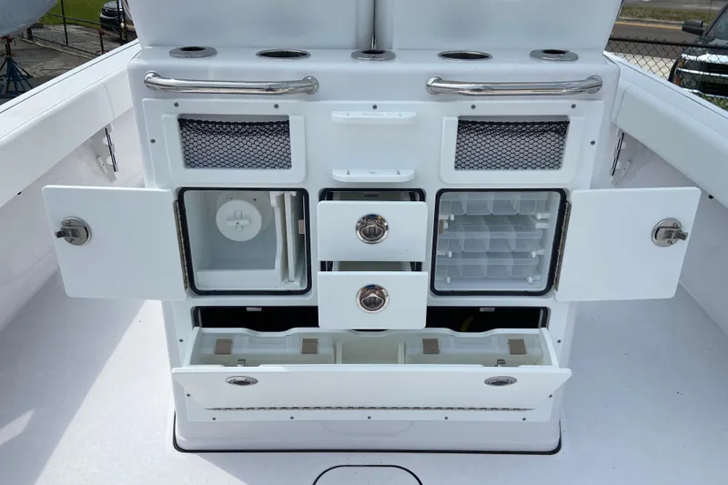 Slide: The Image of 2026 Sportsman Masters 267 Bay Boat storage compartments and drawers open for viewing. - 18