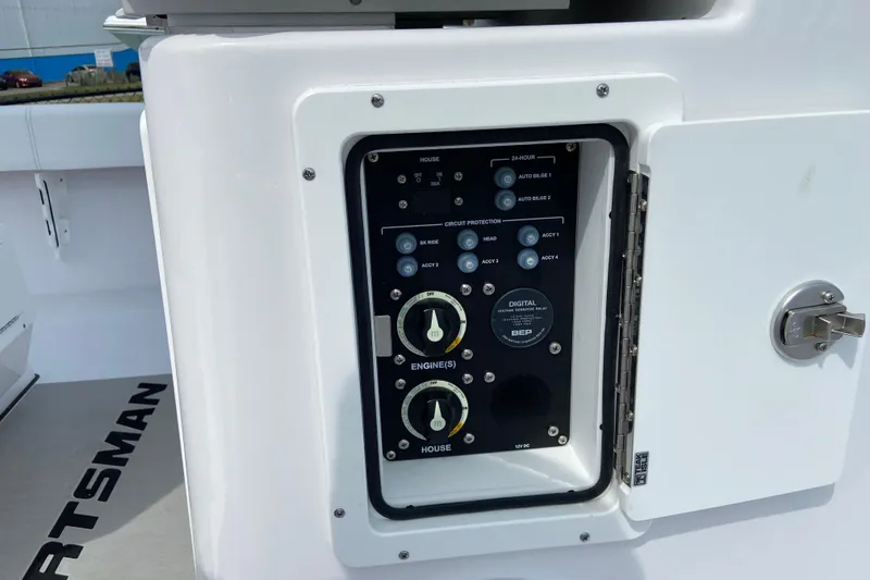 Slide: The Image of Control panel on a 2026 Sportsman Masters 267 Bay Boat, featuring circuit protection switches. - 20