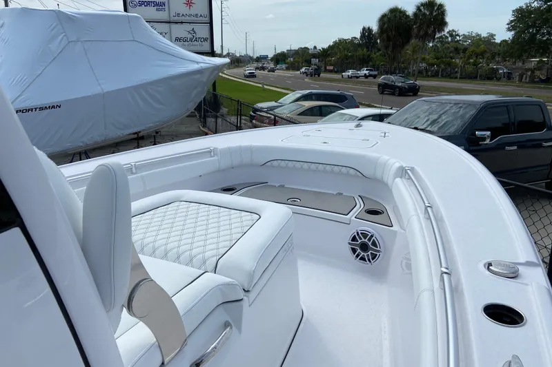 Slide: The Image of 2026 Sportsman Masters 267 Bay Boat with white seating and deck, parked outdoors. - 27