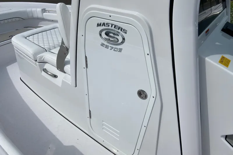Slide: The Image of 2026 Sportsman Masters 267 Bay Boat interior with seating and storage compartment. - 30