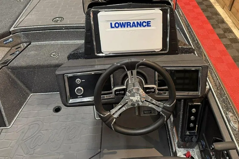Slide: The Image of 2026 Ranger Z520R Cup-Equipped boat dashboard with Lowrance display and steering wheel. - 8