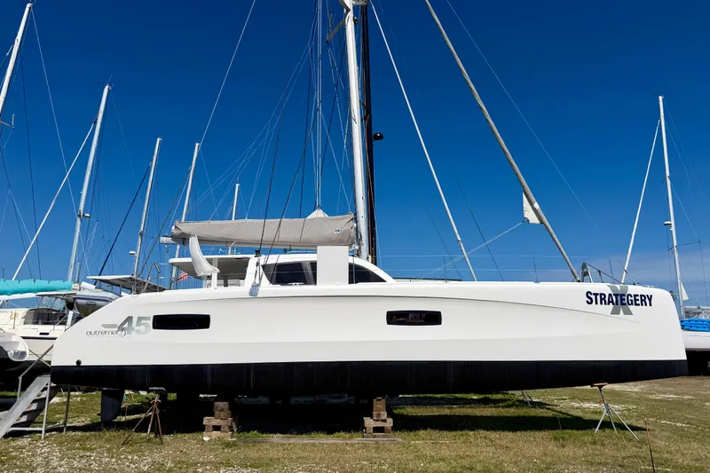 The Image of 2014 Outremer 45 catamaran on land, clear blue sky background. - 0
