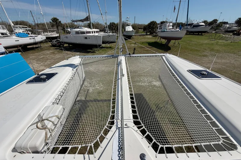 Slide: The Image of 2014 Outremer 45 catamaran on land, showcasing deck and netting. - 20