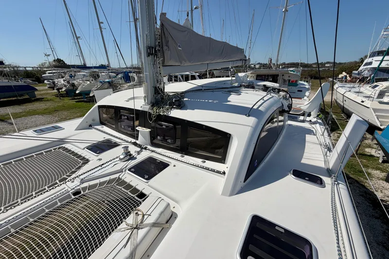 Slide: The Image of 2014 Outremer 45 catamaran on land, showcasing deck and rigging details. - 24