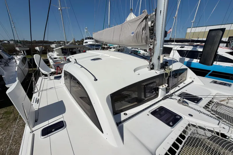 Slide: The Image of 2014 Outremer 45 catamaran docked, showcasing sleek design and spacious deck. - 25
