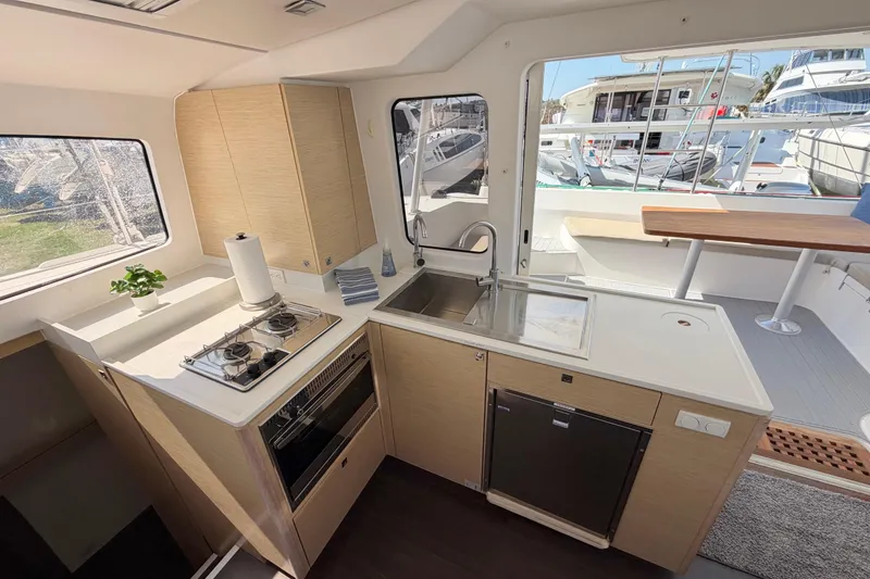 Slide: The Image of Modern kitchen interior of 2014 Outremer 45 catamaran with stove, sink, and outdoor view. - 34