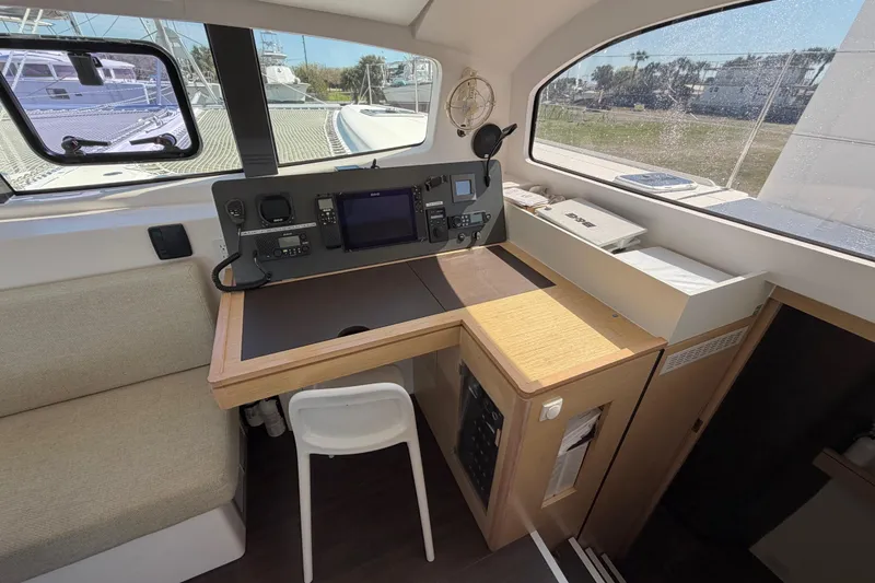 Slide: The Image of Navigation station inside 2014 Outremer 45 catamaran, featuring control panel and seating. - 41