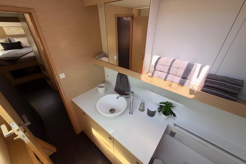 Slide: The Image of Modern bathroom interior of 2014 Outremer 45 yacht with sink, towels, and plant. - 48