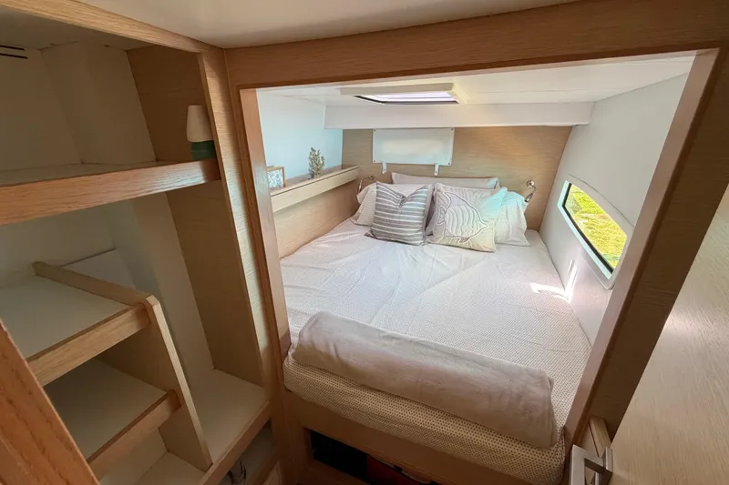 Slide: The Image of Cozy bedroom interior of 2014 Outremer 45 catamaran with natural light and wooden accents. - 54
