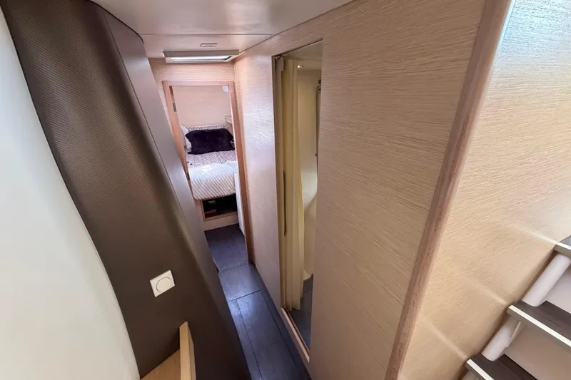 Slide: The Image of Interior hallway of a 2014 Outremer 45 catamaran, featuring modern design and cozy cabin. - 56
