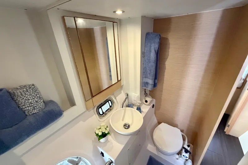 Slide: The Image of Bathroom interior of 2014 Outremer 45 yacht, featuring sink, toilet, and mirror. - 58