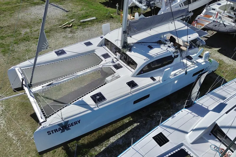 Slide: The Image of 2014 Outremer 45 catamaran on land, showcasing sleek design and spacious deck. - 6