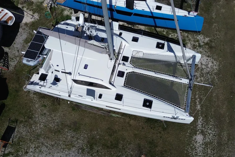 Slide: The Image of Aerial view of 2014 Outremer 45 catamaran with solar panels and netting on deck. - 7