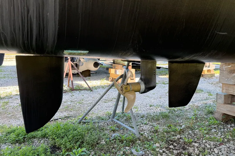 Slide: The Image of Engine compartment of a 2014 Outremer 45 catamaran, showcasing mechanical components and wiring. - 79